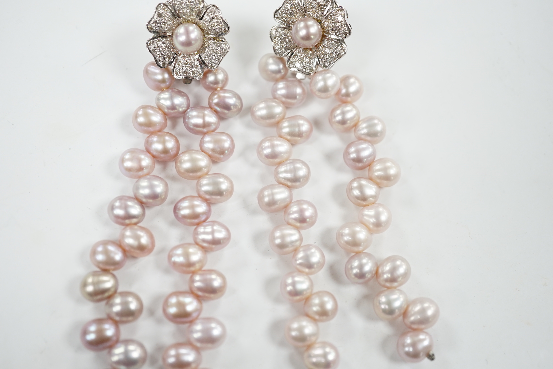 A modern pair of white metal, diamond chip cluster and three row pink cultured pearl tassel drop earrings, 91mm.